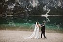 bride reaching for her groom waiting for her- Dolomites Elopement