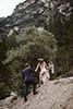 groom helping his bride in the rocky dolomites ground- Dolomites Elopement