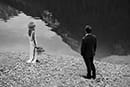 bride and groom admiring the lake in black and white- Dolomites Elopement