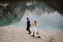 bride and groom walking hand in hand in the wonders of Dolomites- Dolomites Elopement
