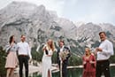 bride opening wine to celebrate their elopement- Dolomites Elopement