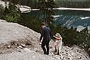 bride and groom helping each other in the rocky road- Dolomites Elopement