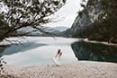 bride walking near the lake of Dolomites- Dolomites Elopement