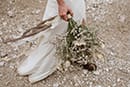 bride holding her bridal florals while walking- Dolomites Elopement