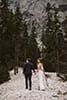 bride and groom walking hand in hand while admiring Italy's treasure- Dolomites Elopement