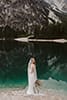 bride standing featuring back bridal dress and veil- Dolomites Elopement