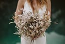 bride holding her beautiful bridal florals while standing- Dolomotes Elopement