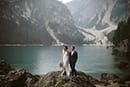 bride and groom standing in the big rock and admiring the beauty surrounding them- Dolomites Elopement