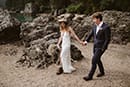 bride and groom walking hand in hand in the rocky side of Dolomites- Dolomites Elopement