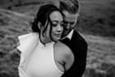 bride and groom hugging in the middle of the mountains- Queenstown Wedding