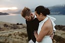 bride and groom walking together in the midst of grassy mountain- Queenstown Wedding