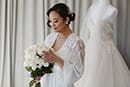 bride admiring her florals while getting ready for their wedding ceremony- Queenstown Wedding