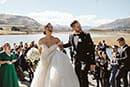 bride and groom happily walking down the aisle as newly husband and wife- Queenstown Wedding
