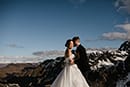bride and groom standing in the middle of the snowy mountain- Queenstown Wedding
