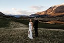 bride and groom standing in the middle of the beautiful mountain view- Queenstown Wedding