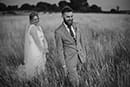 bride and groom happily having fun in their bridal photoshoot in the middle of tall grass- Taupo Wedding
