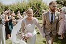 bride and groom walking the aisle happily as newly husband and wife- Taupo Wedding