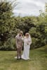 bride and groom after their wedding ceremony in the middle of tall trees and grass admiring each other- Taupo Wedding