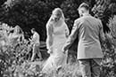 groom helping his bride fix her bridal dress in the grassy road- Taupo Wedding