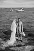 bride and groom in the edge of the sea admiring its beautiful view- Taupo Wedding