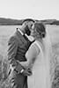 bride and groom hugging in the middle of tall grass- Taupo Wedding