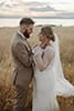 bride and groom staring lovingly at each other as the sun starts to set- Taupo Wedding