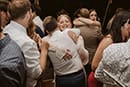 bride hugging their guests in the middle of their wedding party- Taupo Wedding